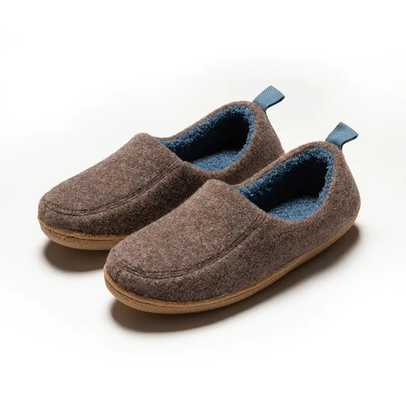 Pair of brown slippers with blue lining on a white background