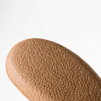 Close-up of a brown makeup swatch on a white background